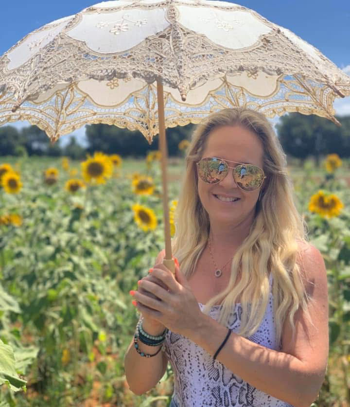 Melissa Muller outdoors in nature, experiencing lifestyle freedom through Prosperity Of Life after leaving traditional 9–5 work behind.