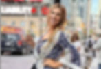 Kristine standing on the streets of Toronto, enjoying the city after a day of training and events.