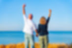 Sarah Hampel and her husband Damian celebrating success at the beach — a joyful moment that reflects the freedom to make money while traveling and living the Prosperity Of Life lifestyle.
