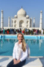 Kerry Young standing in front of the Taj Mahal, blending travel and entrepreneurship as she builds her online business while exploring the world.