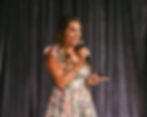 Kristine speaking on stage at a Prosperity Of Life event in Australia, addressing a large audience.