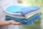 woman-holding-folded-clothes-hands-closeup_cg1p69608185c_th.jpg