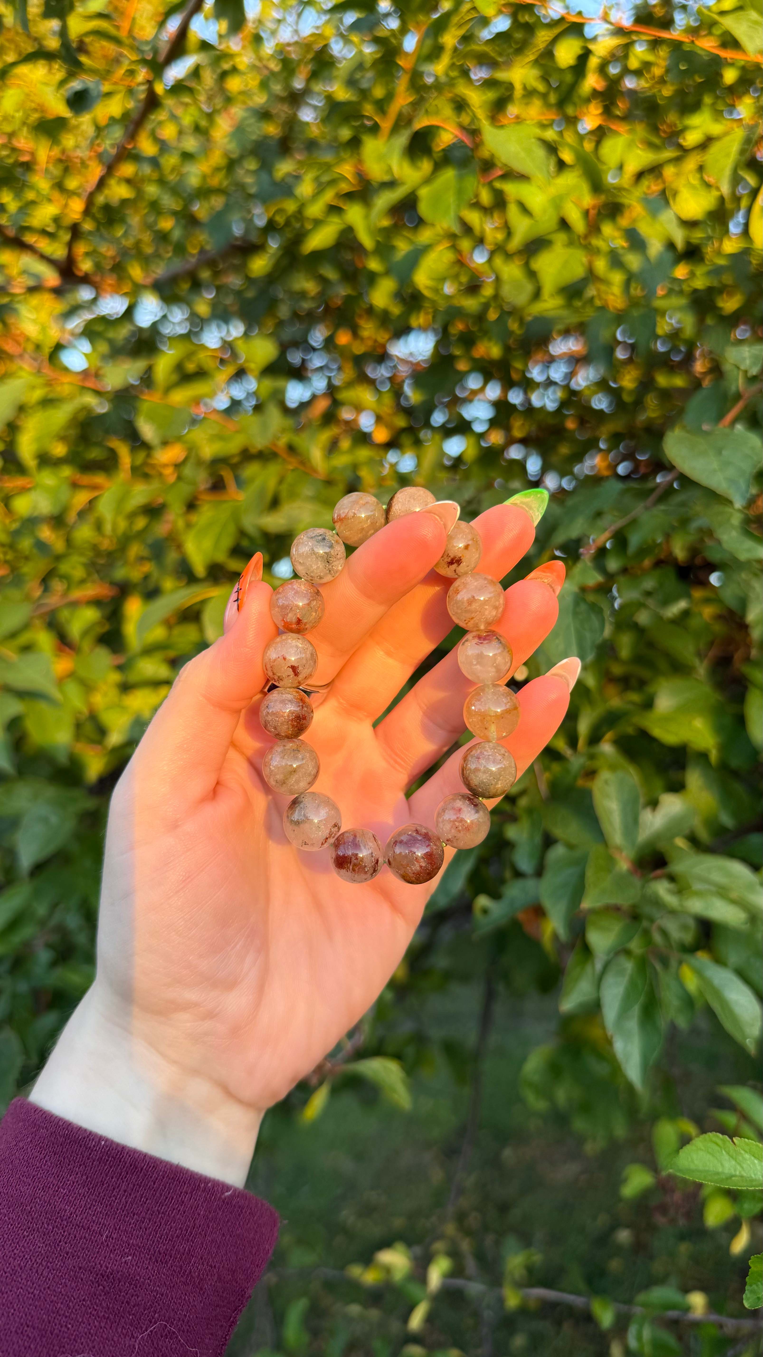 Garden Quartz crystal stretch bracelet featuring round polished translucent quartz beads with natural earthy brown, red, and