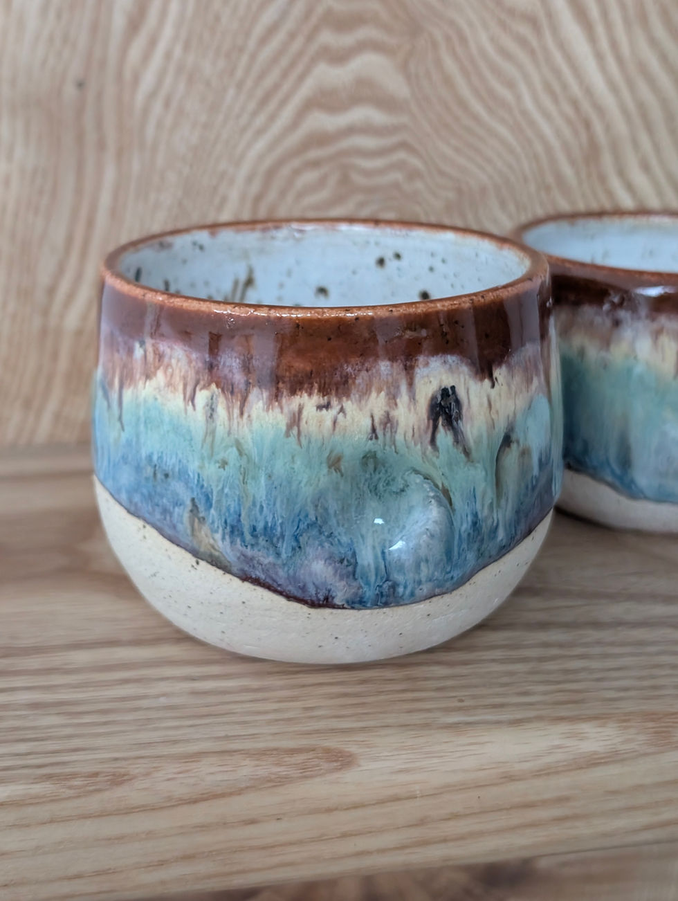 dimpled handleless mug with rustic rainbow gradient glaze in flat white and latte size