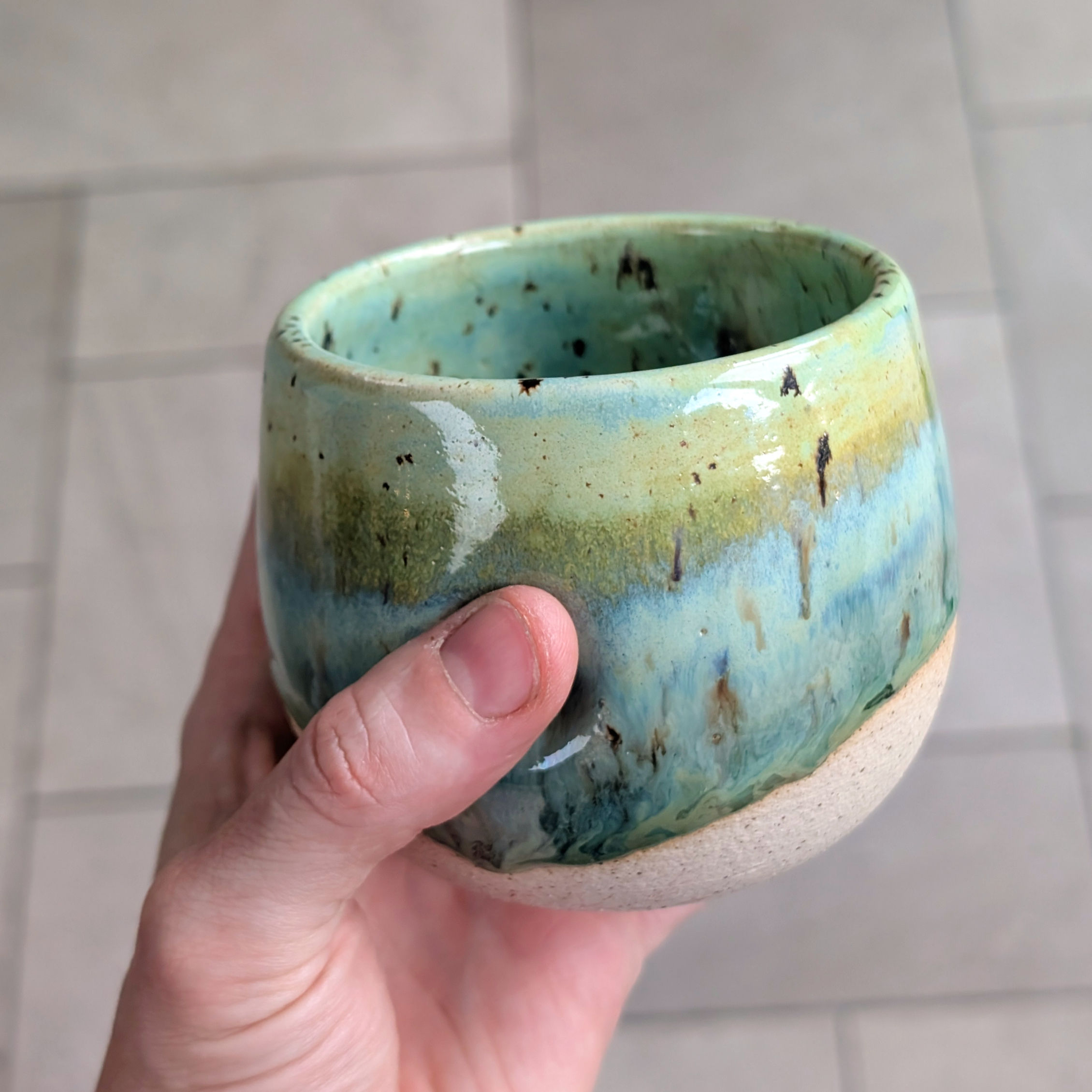 dimpled handleless mug with green gradient glaze in flat white and latte size