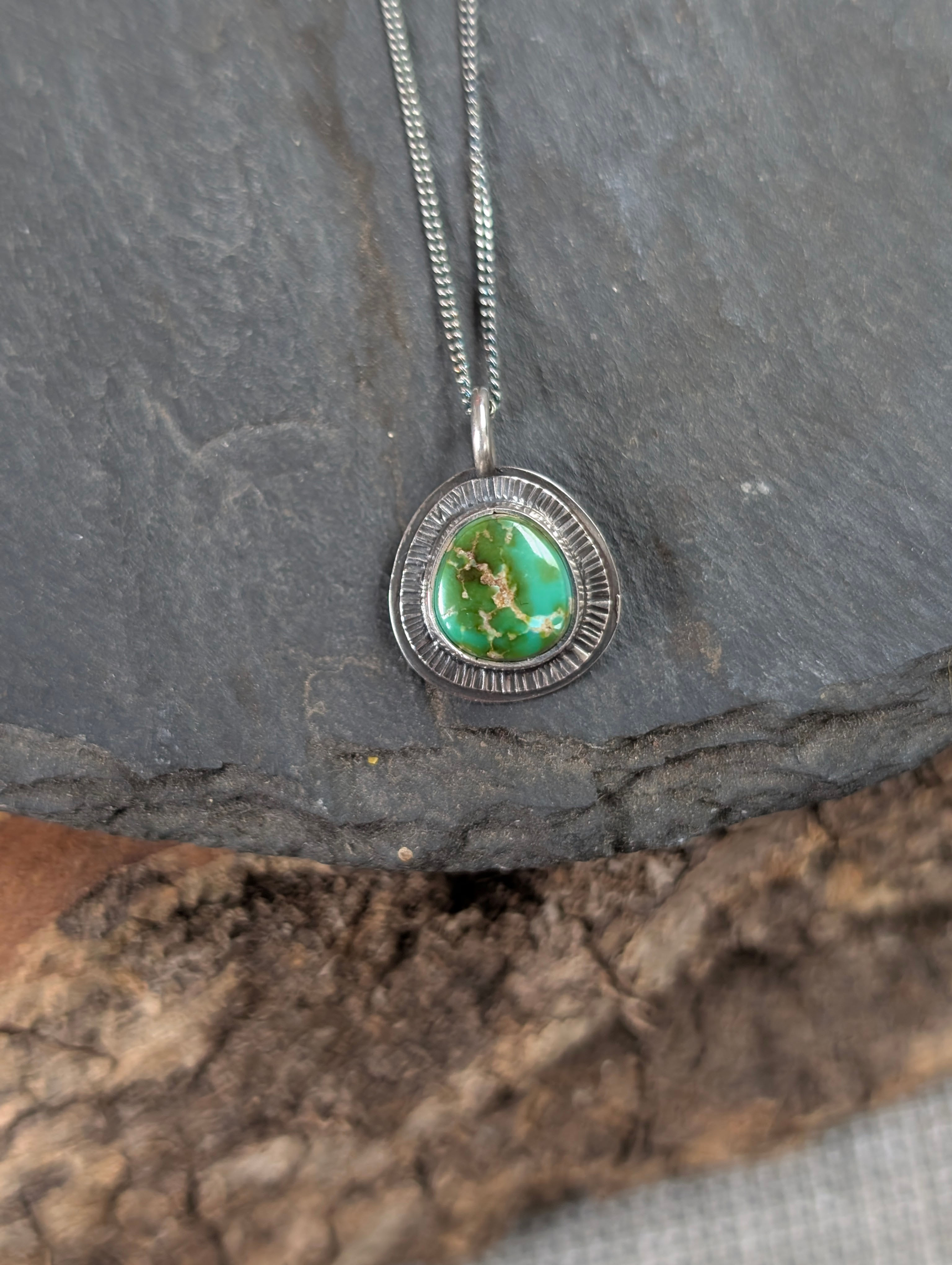 Handmade oxidised sterling silver pendant necklaces featuring a green Sonoran Mountain Turquoise stone with sunburst design