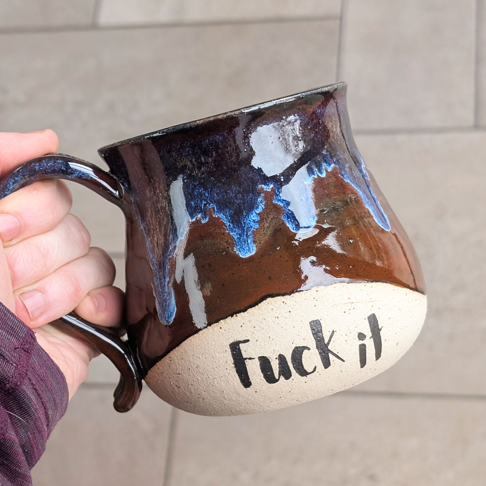 Unique stoneware fuck it mug featuring a deep, glossy red glaze with striking blue drips