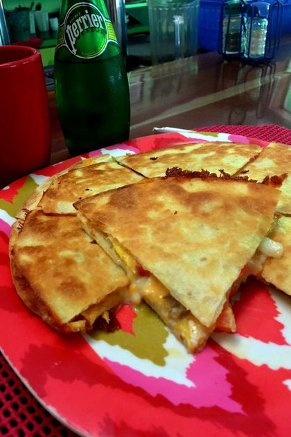 Quesadillas and Perrier at an outdoor dining table
