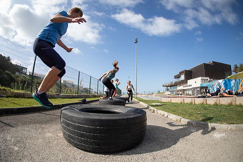 People doing tire jumps