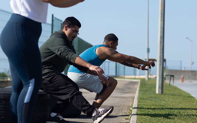 Guys performing pistol squats on tires