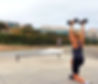Overhead walking lunges at the skatepark