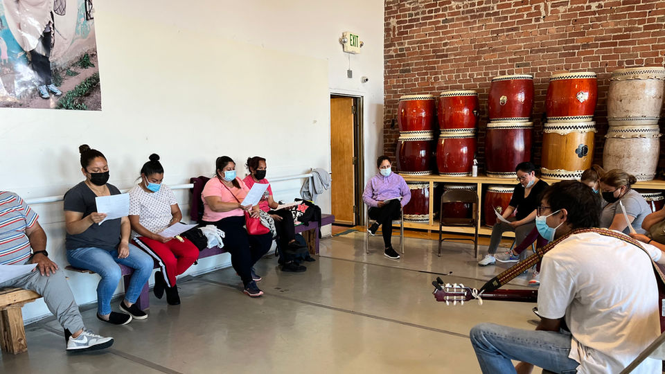 Musical Director Jose Lobo leading group in song.

Photo courtesy of the artist. 