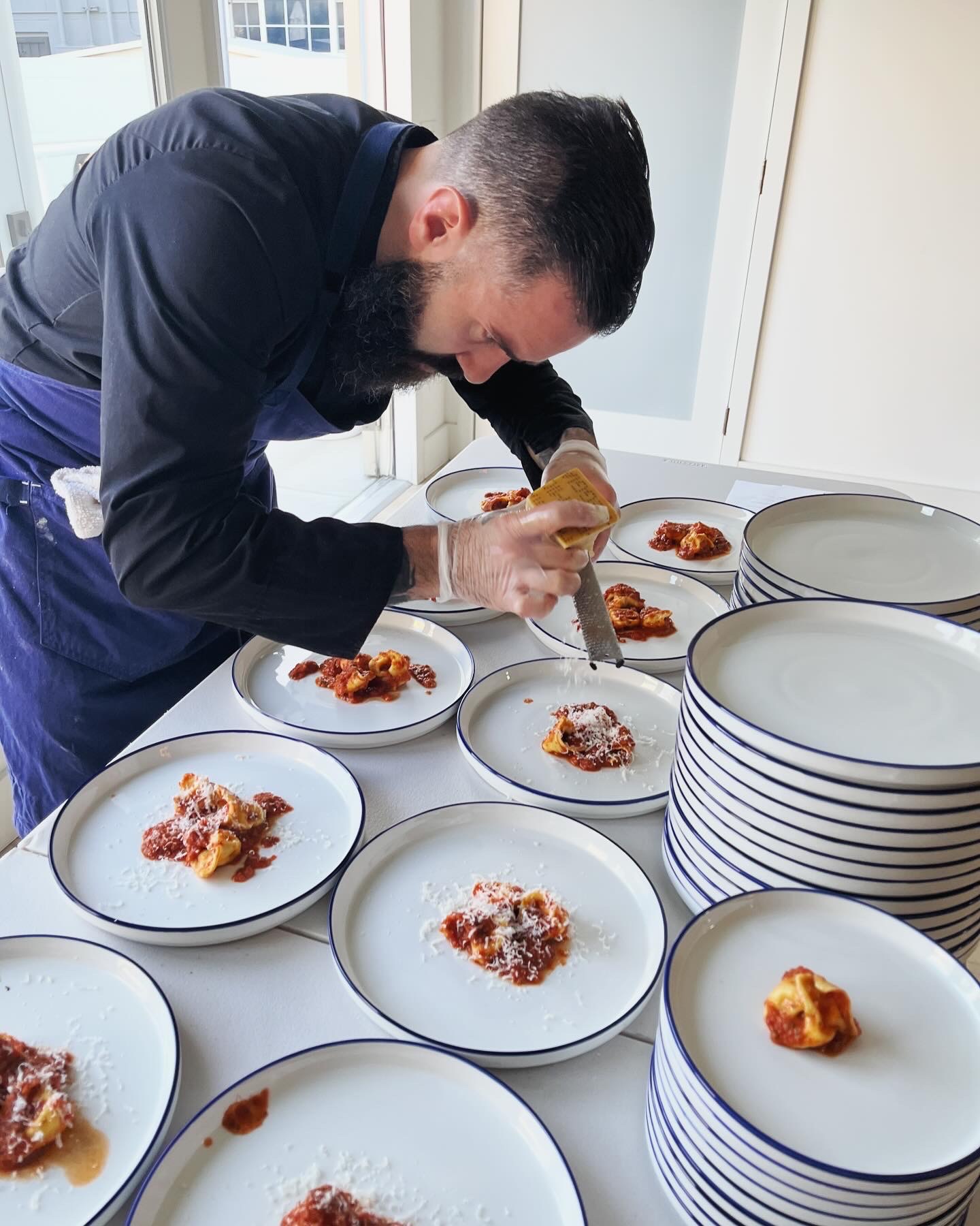 A finished Pasta Mark dish being plated