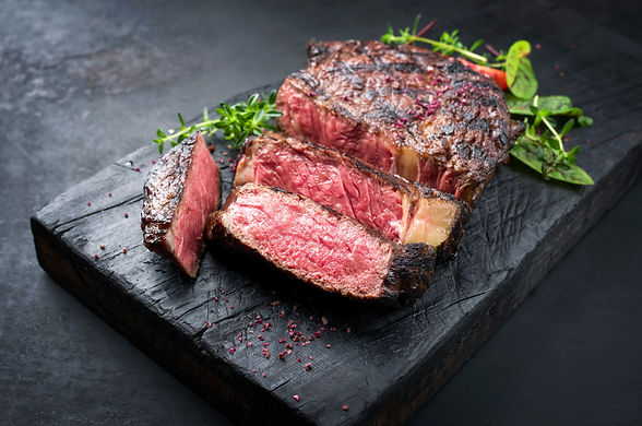 Barbecue dry aged wagyu entrecote beef steak roast with lettuce and salt as closeup on a c