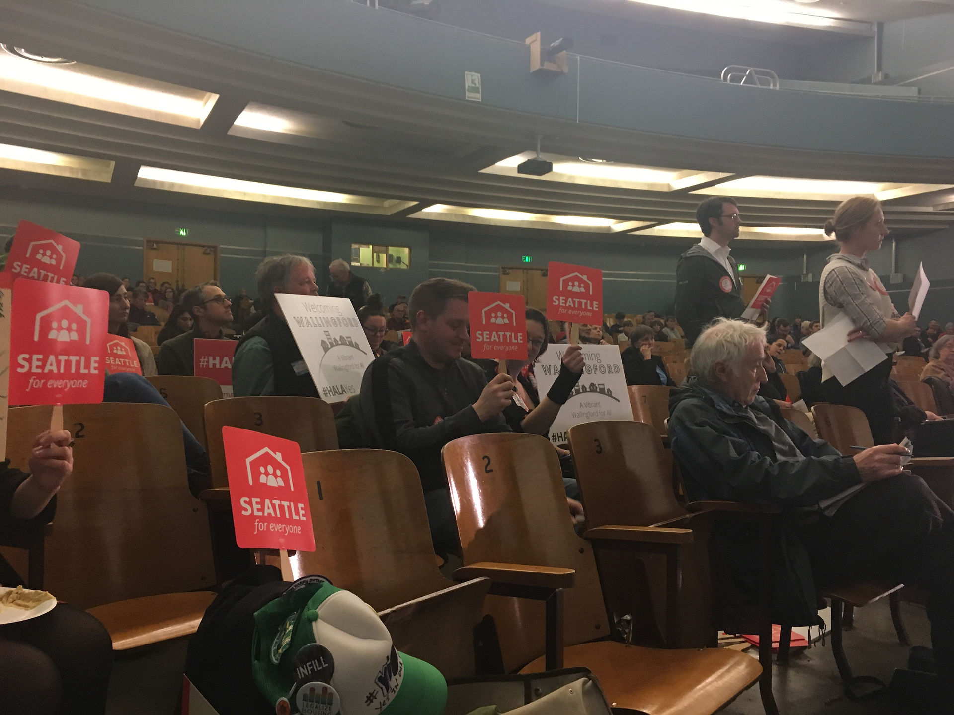 People in support of the City of Seattle's Mandatory Housing Affordability program hold "Seattle for Everyone" signs during a public hearing in District 4