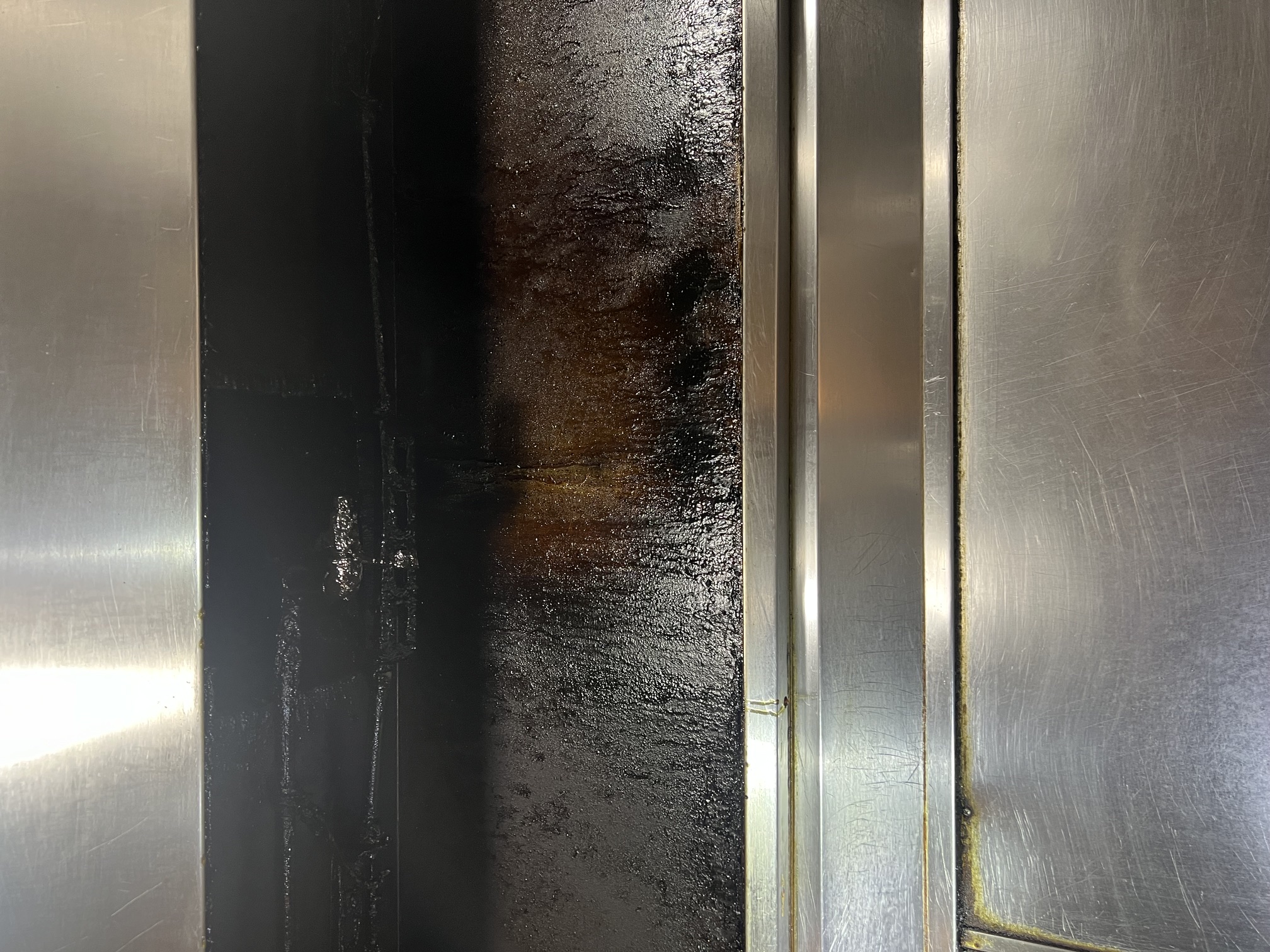Close-up view of a commercial kitchen hood suppression system being inspected