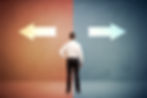 Financial Advisor in white shirt faces two large arrows, one red pointing left and one blue pointing right, symbolizing a decision-making moment.