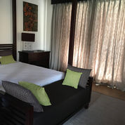 Villa living room with sofa, cushions, and drapes