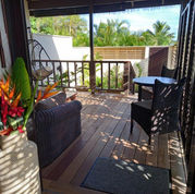 Indoor villa living looking out to private garden courtyard and tropical decore