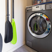 Guest washing machine with kayak paddles hanging on the wall