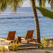 Beach deck chairs facing the turquoise ocean