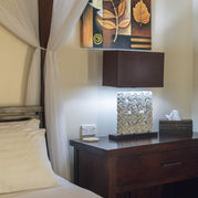 Bedside cabinet and lamp with decorative wall art