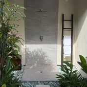 Outside shower framed by a tropical garden