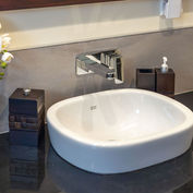 Modern villa bathroom with white basin and granite top