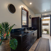 Villa hallway rug with dark timber cabinetry and tropical decor