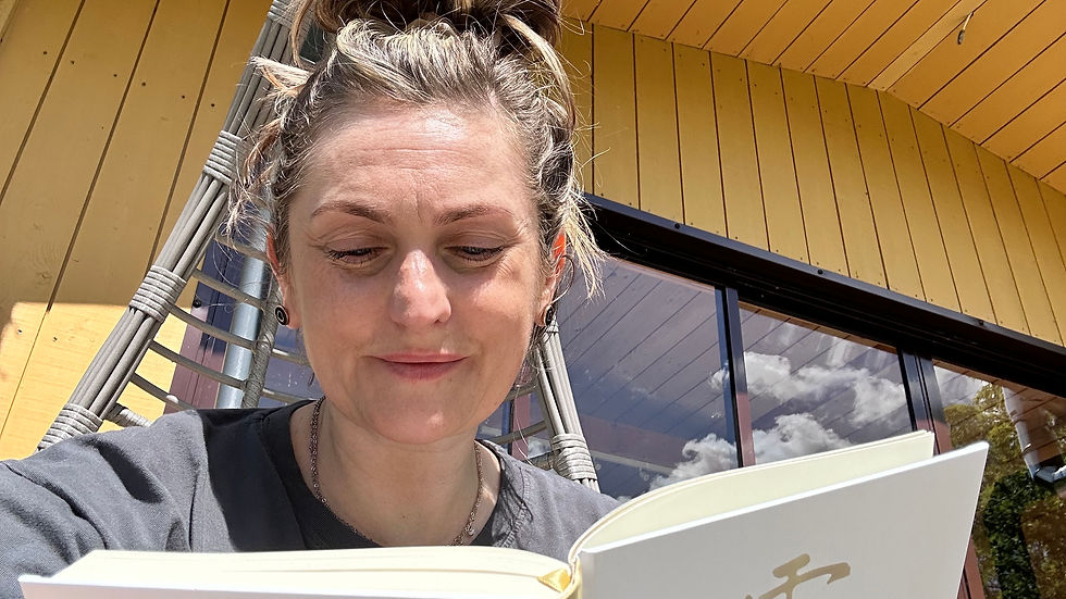Enjoying a peaceful break while diving into a new Reiki book under the sunny sky.