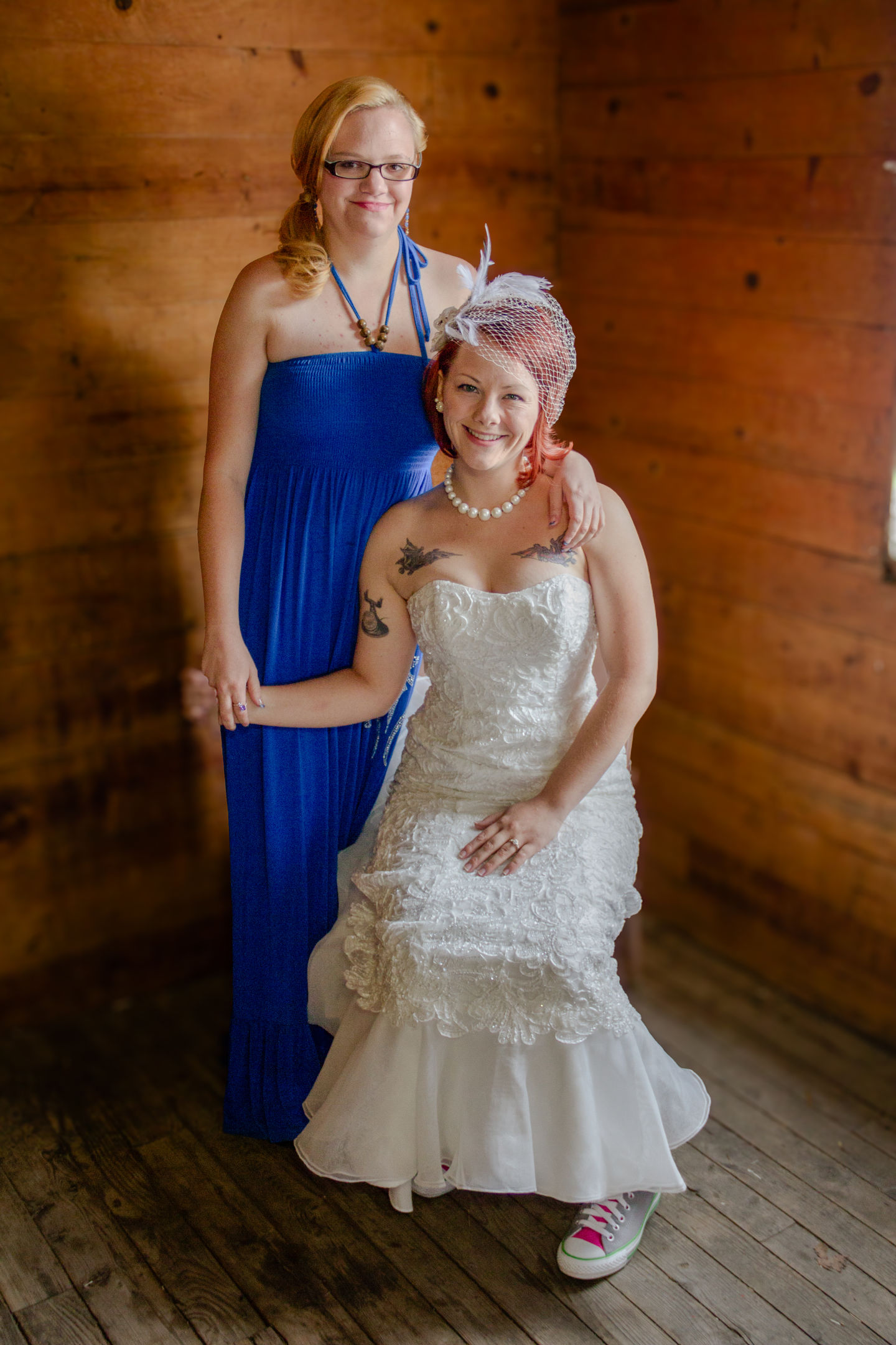 a woman in a blue dress stands next to a woman in a white dress
