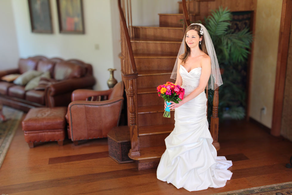 a woman in a wedding dress is holding a bouquet of flowers
