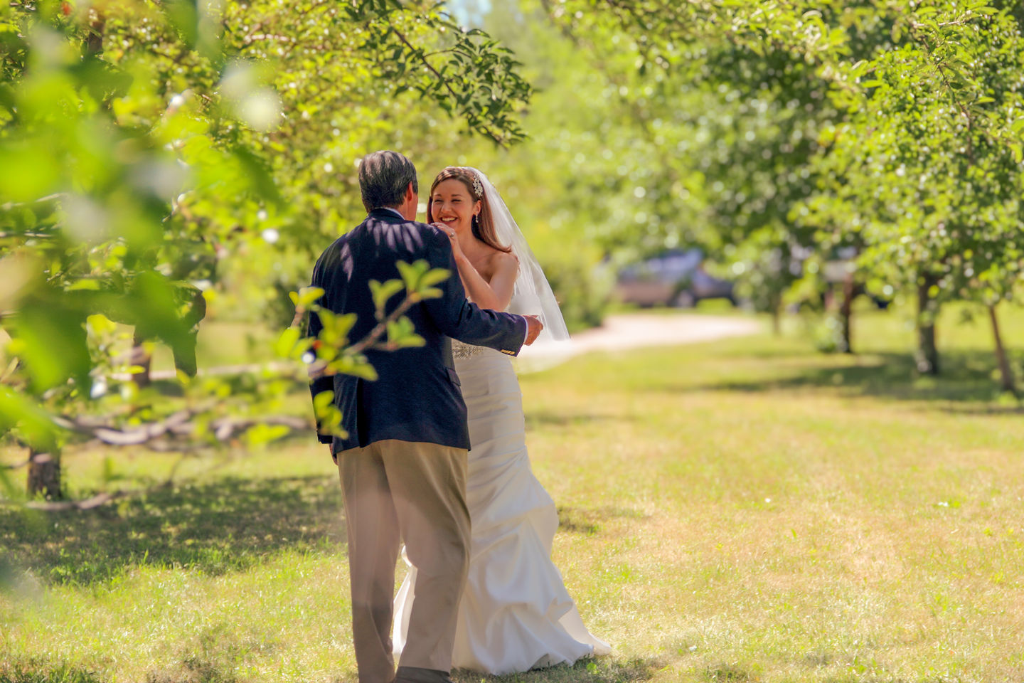 a bride and her father are dancing in the grass