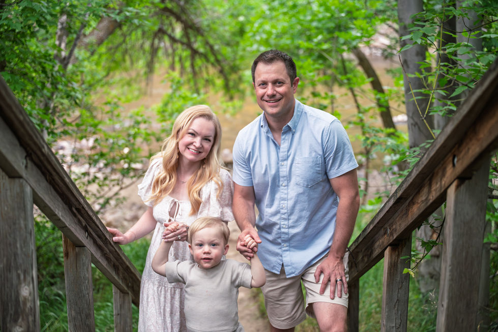 A family posing on wooden steps outdoors.