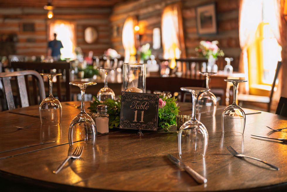Elegant table setting with glasses and centerpiece.