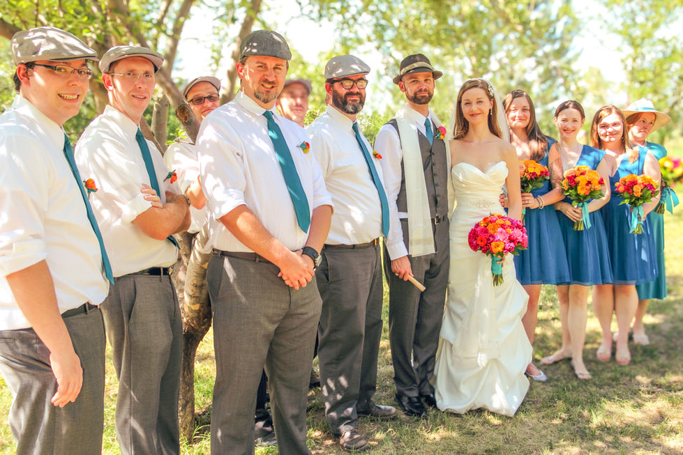 a bride and groom pose with their wedding party