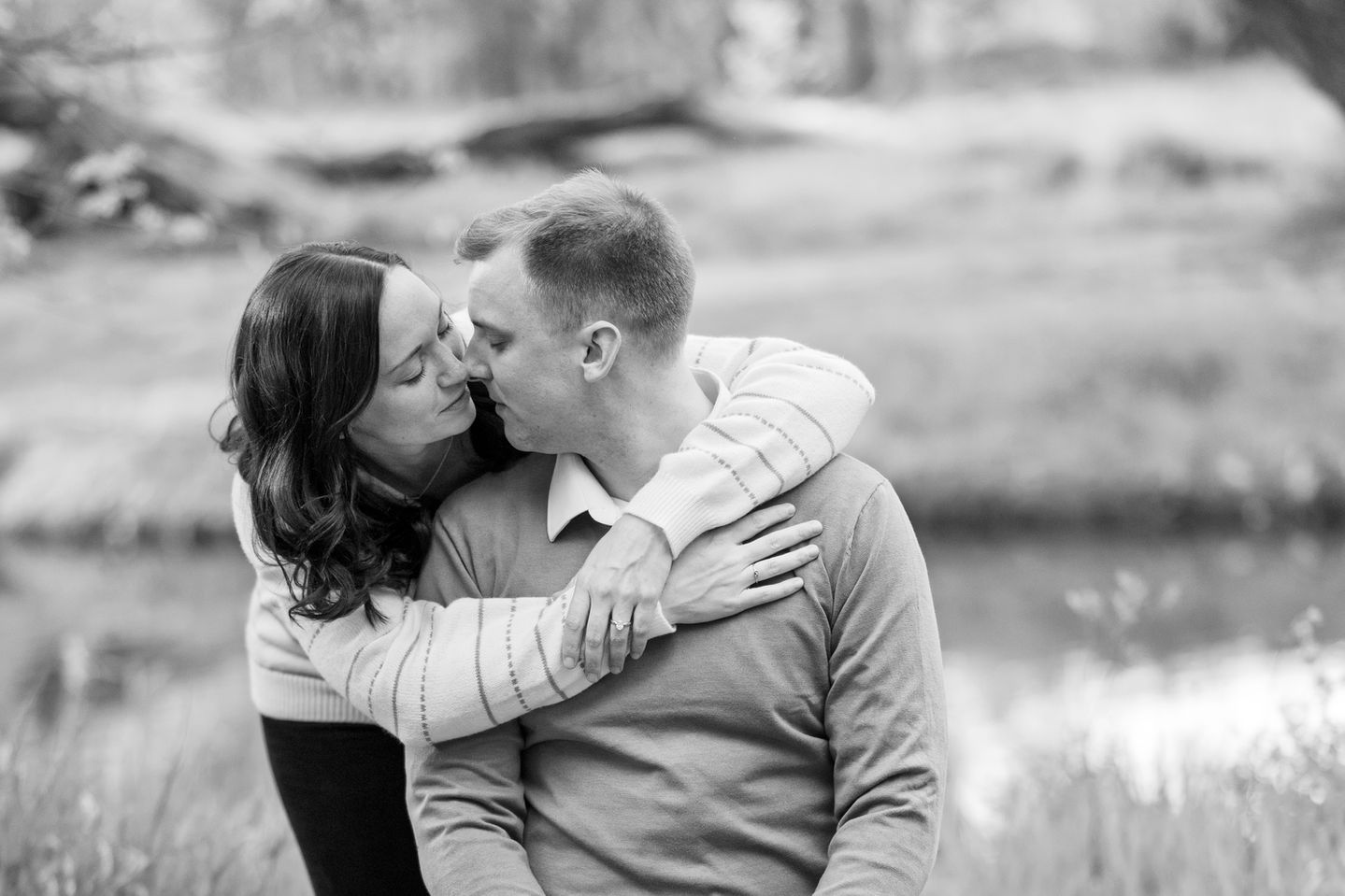 a woman kisses a man on the cheek in a black and white photo
