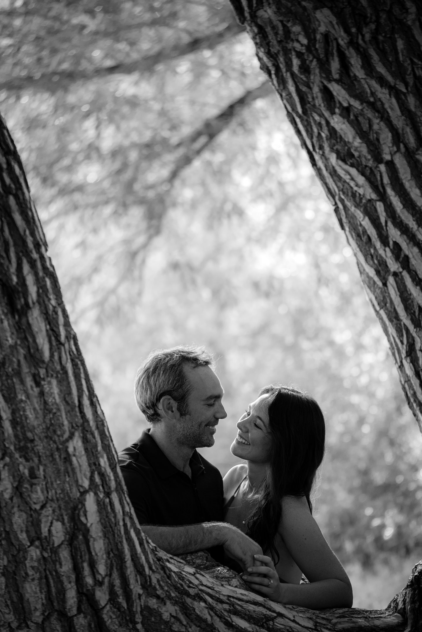 a black and white photo of a man and woman looking into each other 's eyes
