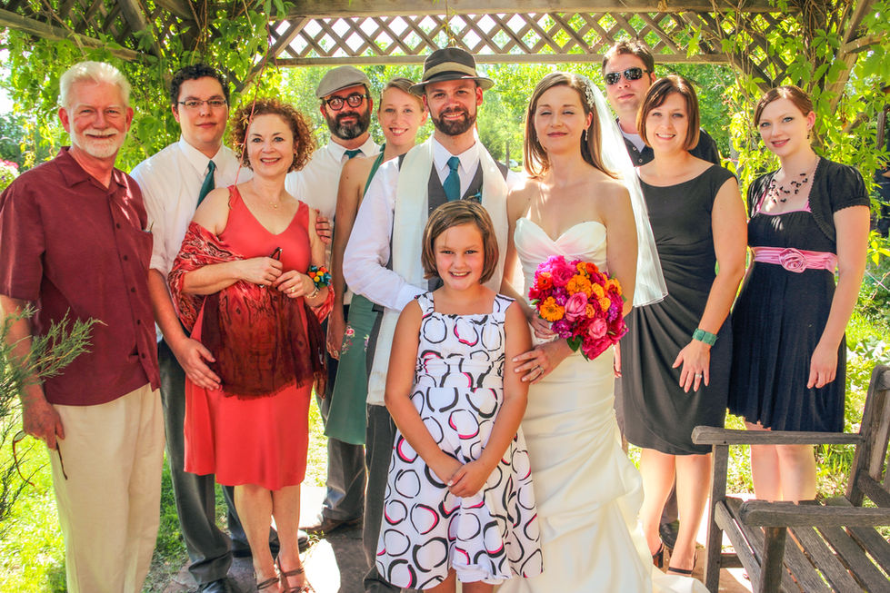 a bride and groom pose with their wedding party