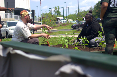 Student listens to planting instructions.