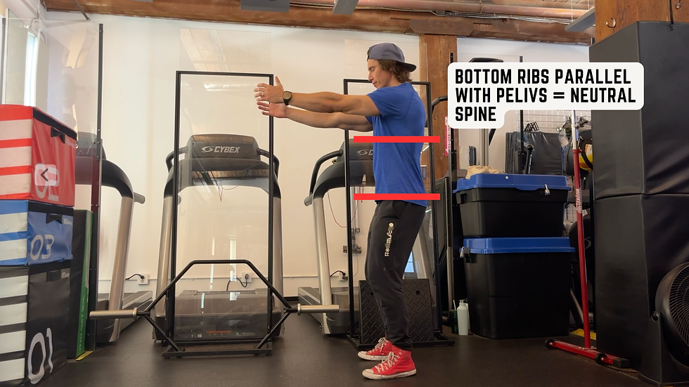 Man in a gym extends his arms forward in a squat cue pose; overlay text reads Bottom ribs parallel with pelvis = neutral spine