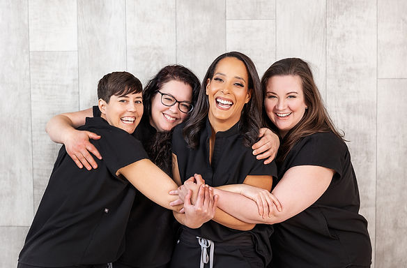The Evergreen Wellness team hugging for a group photo