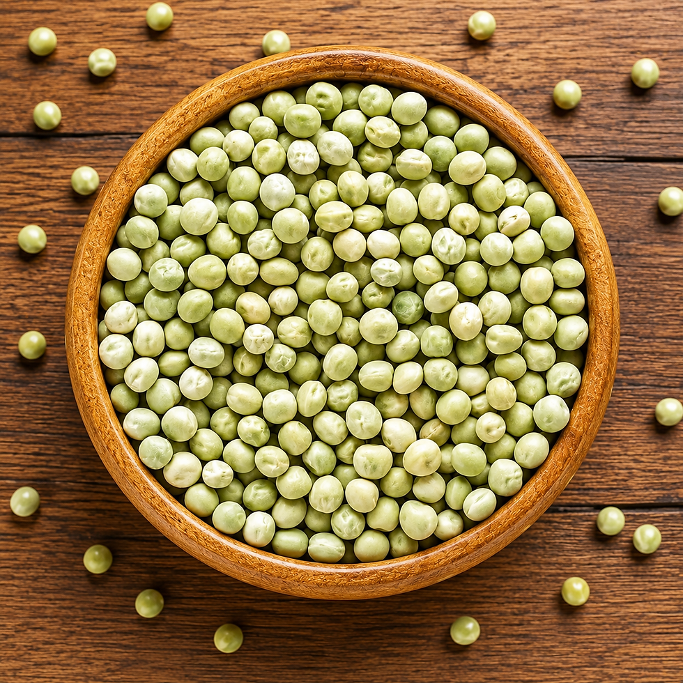 Dried green peas in a wooden bowl on a dark wood surface.