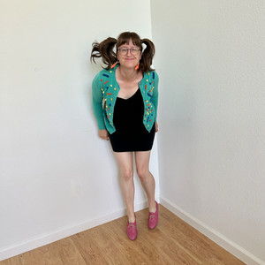 Teal sweater with handmade pompom embellishments. Memphis style color scheme.