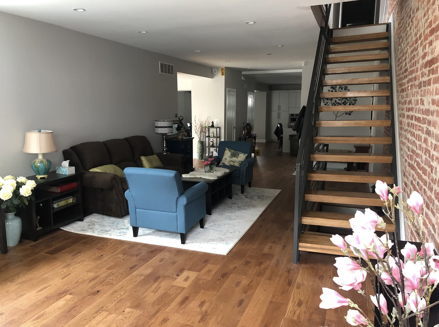 Living space with open stairs and new flooring