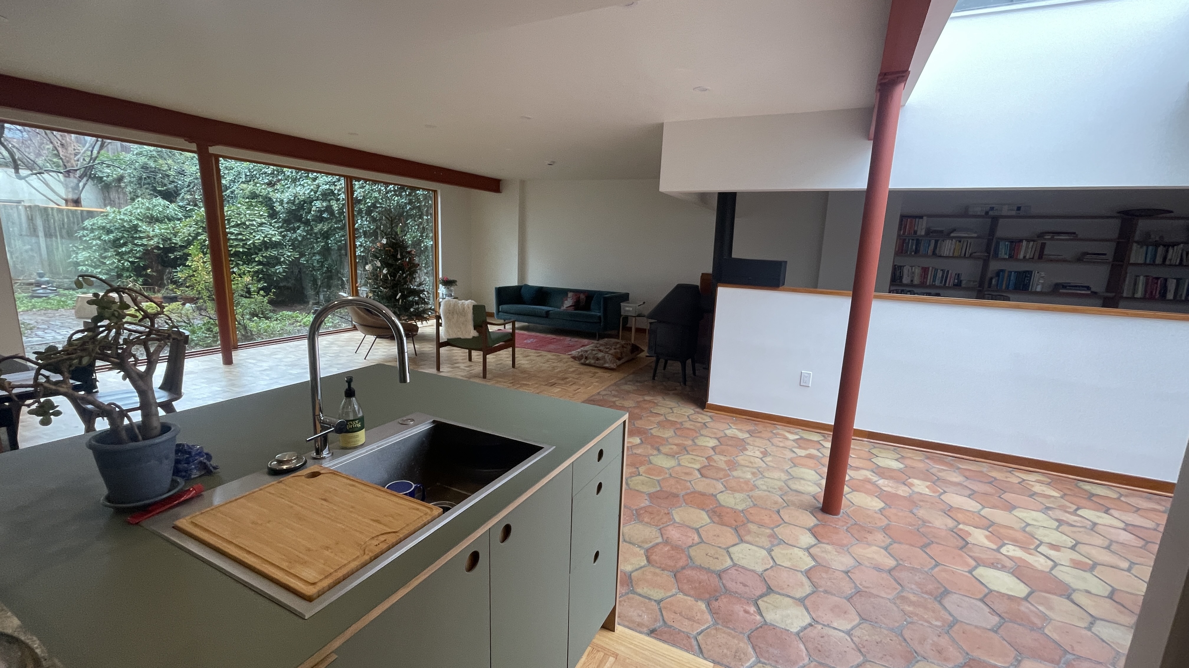 Living area with exposed structure and garden views