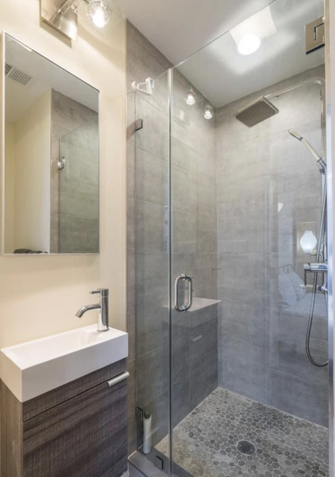 Glass-enclosed tiled shower in a custom bathroom