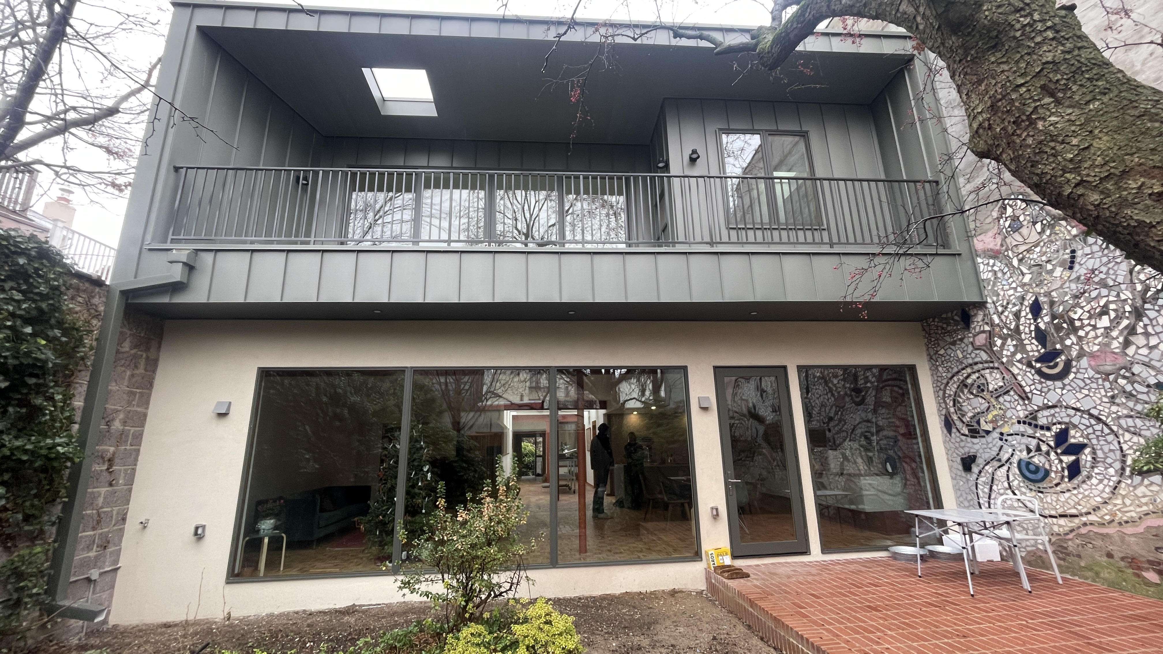 Double-height living space with interior balcony in Queen Village