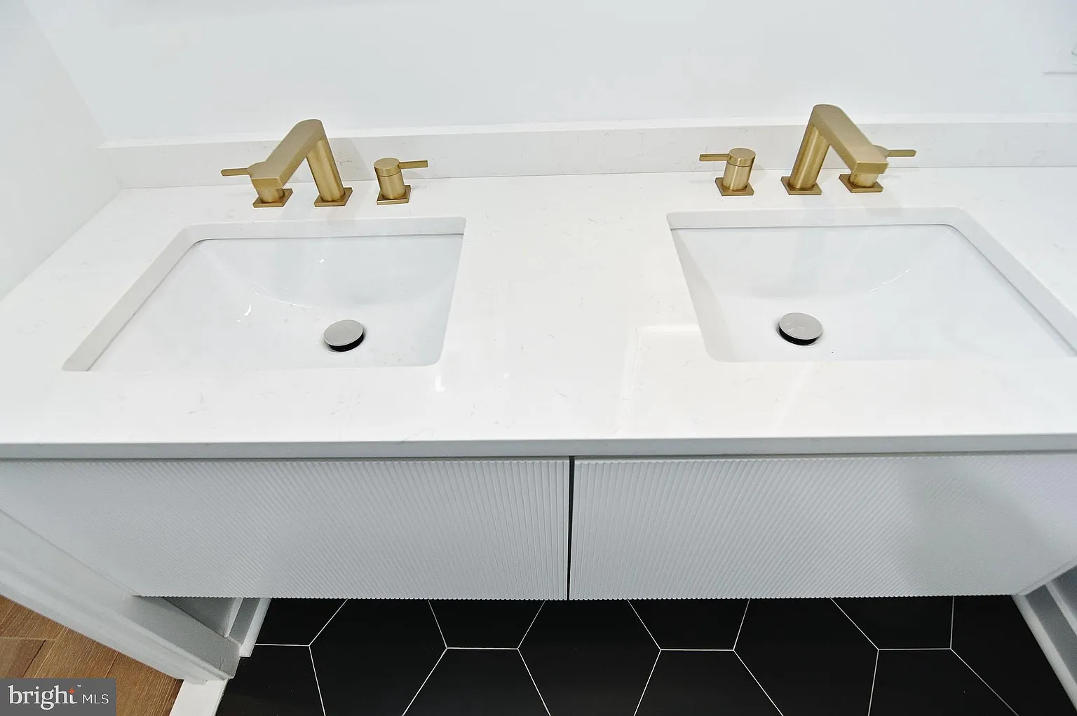 Double vanity with brass fixtures in a custom bathroom