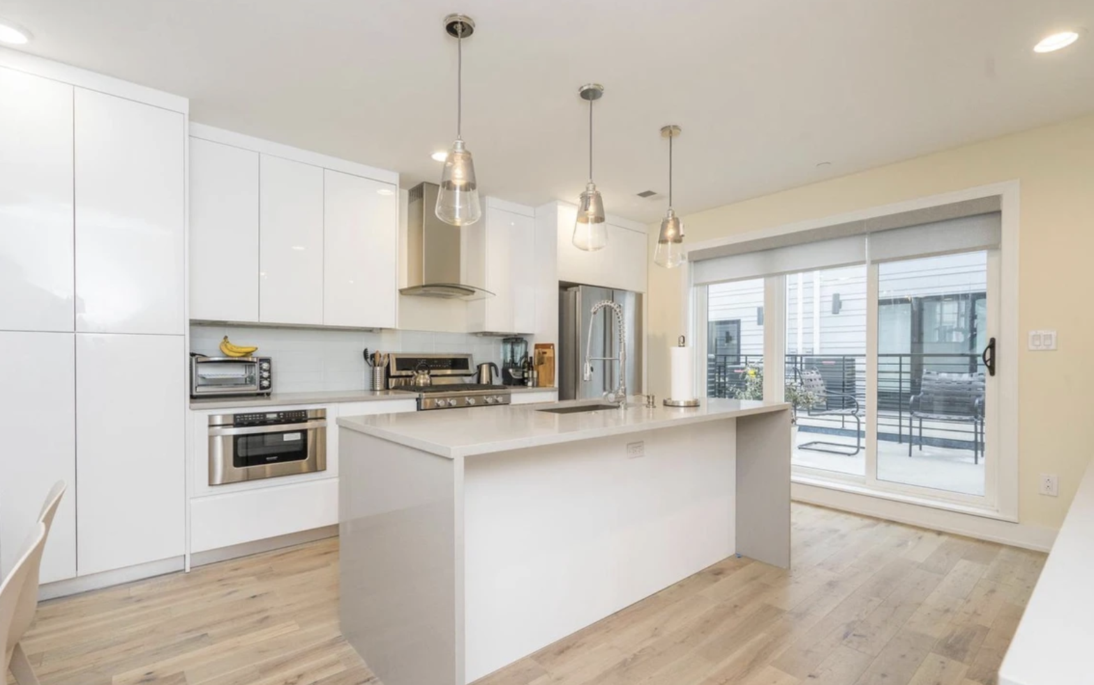 Kitchen with custom cabinetry and pendant lighting
